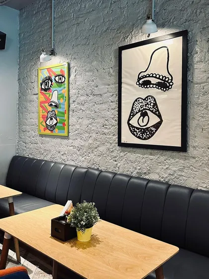 I wanted the cafe to have its own unique personality. The space is decorated with quirky, modern art and offers comfortable booth seating, making it a cool and inviting spot for a meal or coffee.
