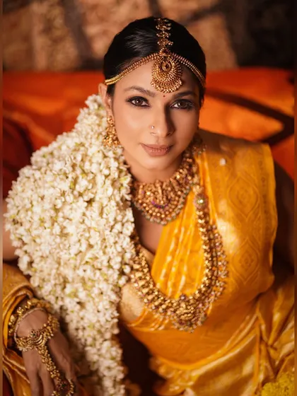 A stunning close-up portrait of Tanishaa Mukerji. This shot showcases the flawless, glowing makeup and the precise placement of the traditional bindi and nose ring.