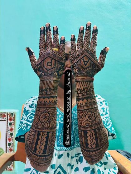 Personalizing your mehendi is my specialty. Here, I've incorporated the couple's initials, 'A' and 'P', into the back of the hands, surrounded by rose and elephant motifs.