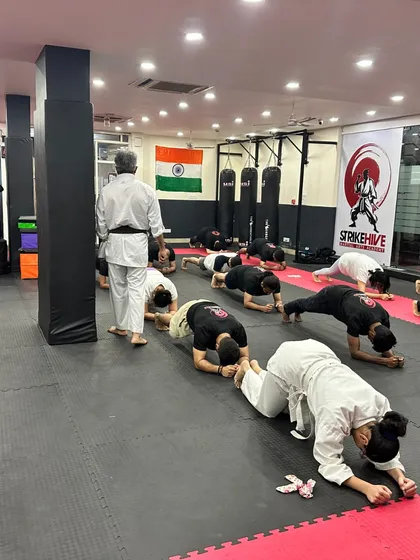Planking it out together. This image shows the collective effort and mutual support during a tough conditioning drill.