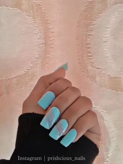 A beautiful light blue set with a soft, smoky marble accent nail. This was done on long, square extensions.