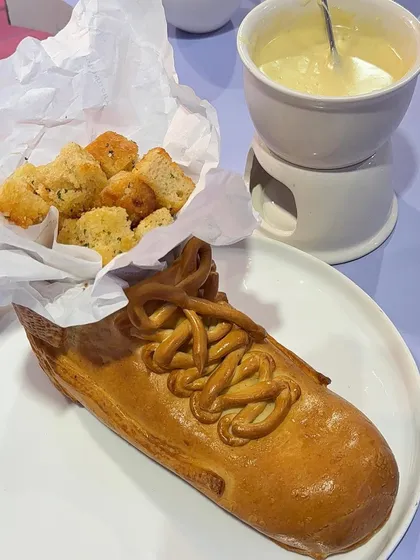 A whimsical bread sculpture shaped like a sneaker, served with a cheese fondue dipping sauce. This creation for the Ajio Luxe pop-up shows our fun and unexpected approach to food presentation.