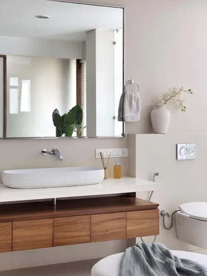 A close-up of the floating vanity in the 'A Walk in the Clouds' master bath, with a vessel sink and wall-mounted faucet.