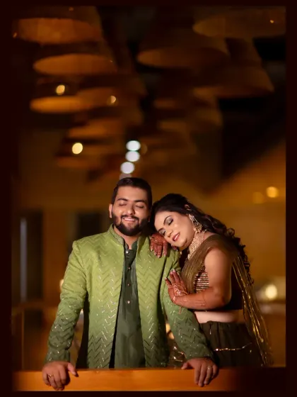 A quiet moment of comfort and peace. The bride rests her head on the groom's shoulder in a beautifully lit indoor space, creating a portrait that is both elegant and full of emotion.