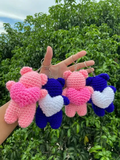 A handful of my bear keychains, available in different color combinations like pink with a pink heart and blue with a white heart.
