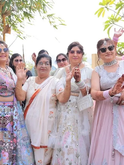 The ladies of the family, sunglasses on, dancing their hearts out in the baraat. It's a celebration for everyone.