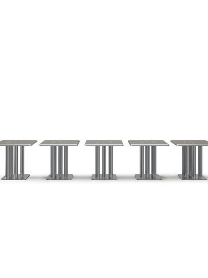 The XOXOX table features a square tabletop and five "X" and "O" shaped legs. This product shot highlights the design's balance of a sturdy, industrial feel with a playful and elegant silhouette.