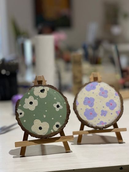 These charming floral patterns were painted on slices of wood, creating rustic and beautiful decorative pieces. A great example of painting on unconventional surfaces.