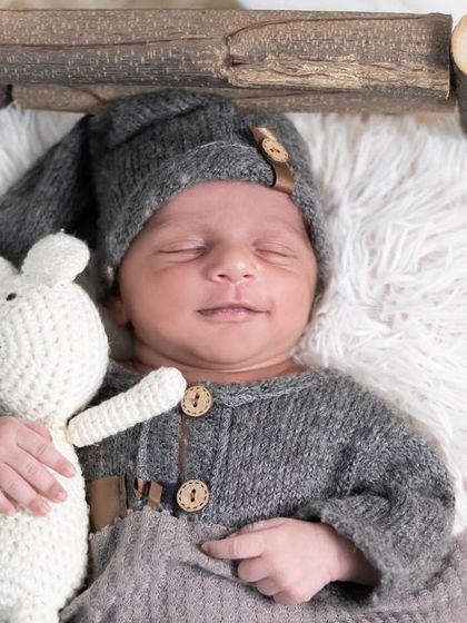 Holding a tiny teddy bear, this newborn is the picture of innocence. We have a variety of safe, soft props for your baby to hold or snuggle with during the session.