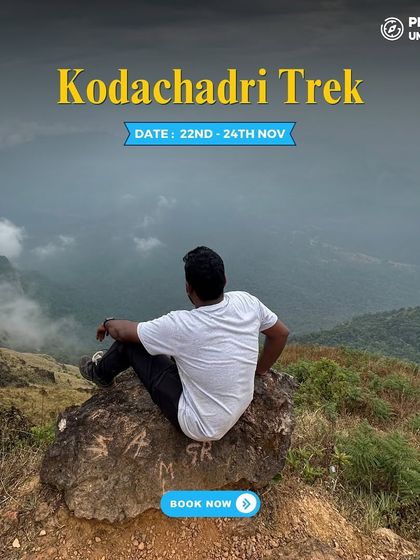 A solo trekker sits peacefully on a rock, overlooking the stunning valleys of Kodachadri. It's a perfect place for reflection.
