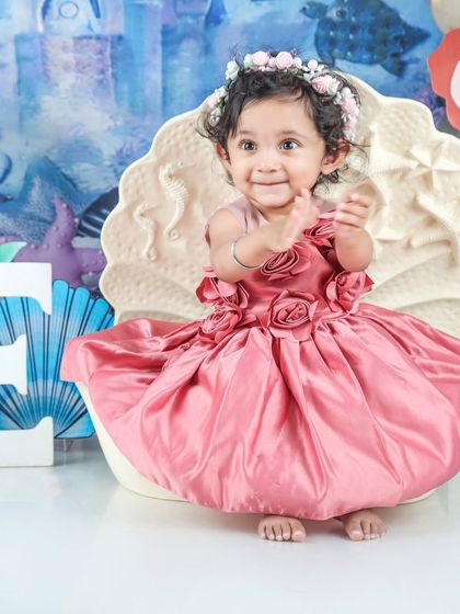 This little mermaid is clapping with joy in her seashell seat. The under-the-sea theme is so colorful and fun.