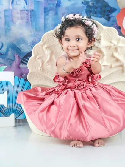 This little mermaid is clapping with joy in her seashell seat. The under-the-sea theme is so colorful and fun.