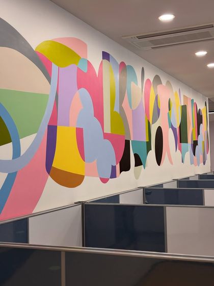 This 42-foot abstract mural brings a wave of color and energy to an office space. The flowing forms are designed to inspire creativity and connection among the people who work here.