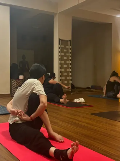 Students in various stages of Marichyasana, a series of seated twists and forward folds that are excellent for spinal health and digestion.