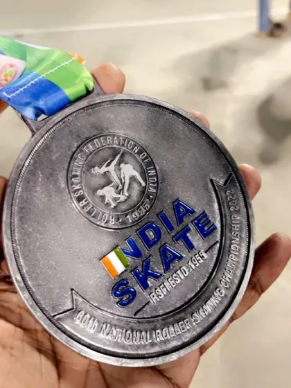 A close-up of the silver medal from the 60th National Roller Skating Championship, an event recognized by the Roller Skating Federation of India.