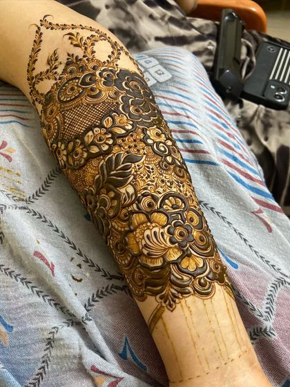 This photo shows the fresh henna paste on a full-arm design. The dark paste is from my homemade organic cones, which results in a rich, long-lasting stain.