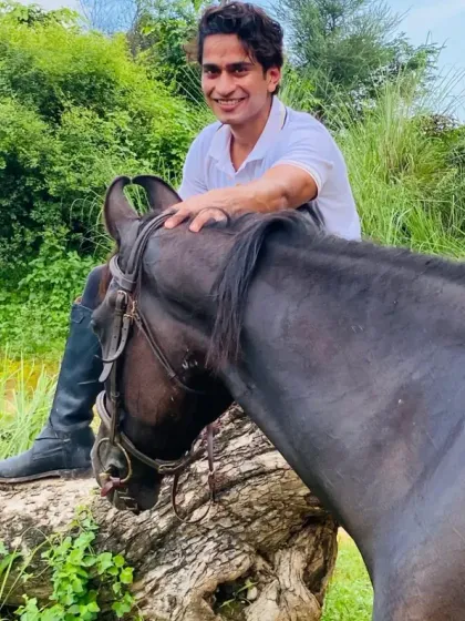 A rider takes a break on the trail to connect with his horse. These quiet interactions build trust and create a partnership for the ride ahead.