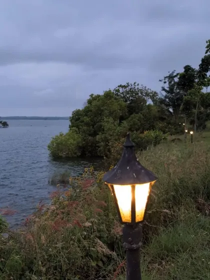 A serene evening view from our backwater campsite. The calm water and glowing lamps create a peaceful atmosphere for a family getaway.