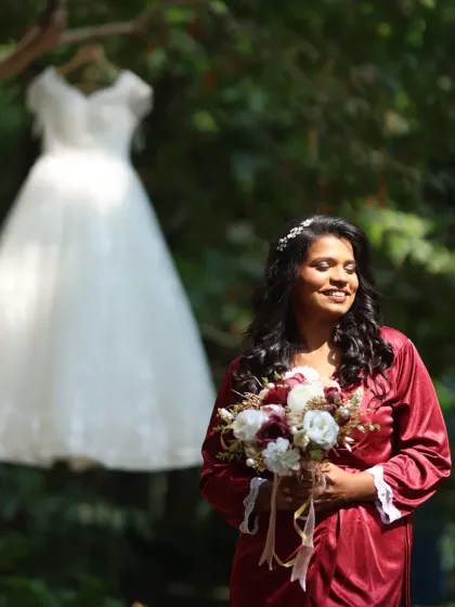 A creative shot of the bride before she gets into her gown. Her makeup is already done, showcasing a natural and radiant look that is ready for the final transformation.