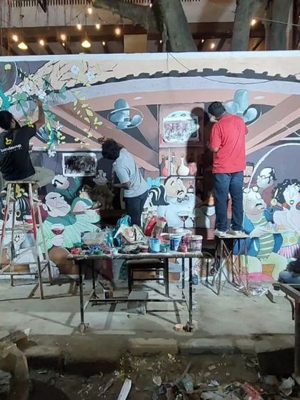 The team at work on the Adda 1522 mural at night. This photo shows the incredible teamwork and coordination it takes to execute such a detailed, character-heavy piece.