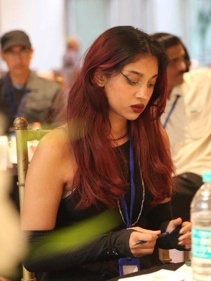 A young writer taking notes during a session. We attract dedicated artists who are serious about honing their craft.