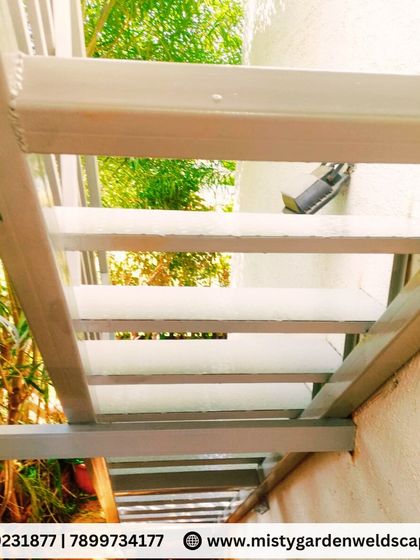 A view from the bottom of a custom-fabricated metal staircase. The open-riser design gives it a light and airy feel, perfect for outdoor applications where you don't want to block light.
