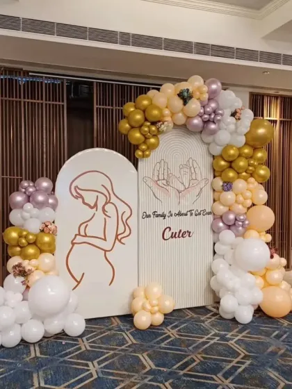 Another angle of the full baby shower backdrop, showcasing the complete balloon arch and its placement in the venue.