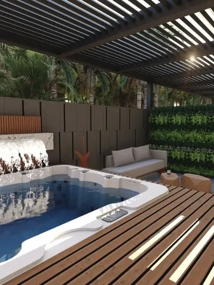 A daytime view of the hotel suite's private jacuzzi area, showcasing the wooden deck, pergola, and a water cascade feature. The design seamlessly integrates luxury amenities with natural textures and greenery.