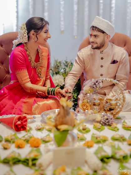 A beautiful moment from a Maharashtrian wedding ceremony, showing the couple during the rituals.