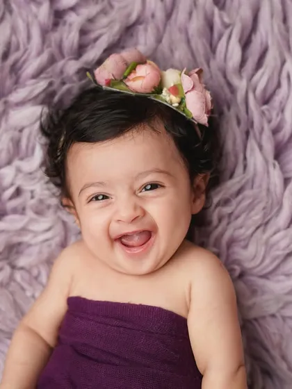 A burst of pure laughter! This photo captures the unrestrained joy of childhood, a memory that is truly priceless.