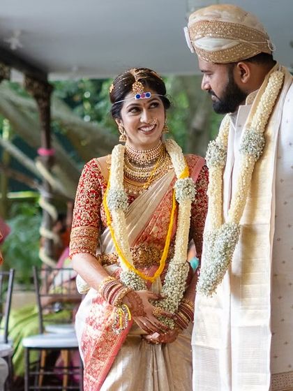 A candid moment of interaction between the couple and the priest during the wedding ceremony.