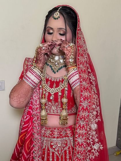 A candid moment of the bride adjusting her nose ring. The soft, glowing makeup ensures she looks perfect from every angle.