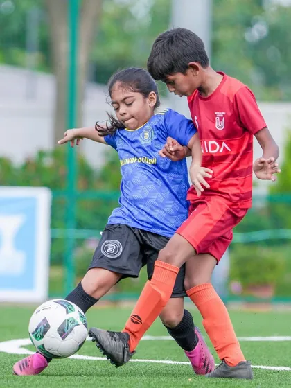 Aarna, the only girl on the team, holding her own and battling for possession.