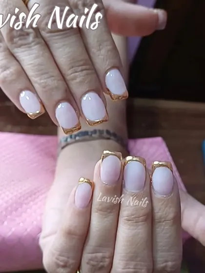 A reverse French manicure with a gold chrome accent along the cuticle line.