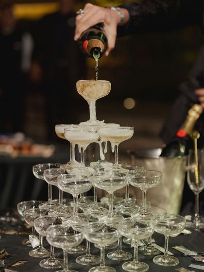 A classic champagne tower, the centerpiece of a glamorous disco-themed after-party. It’s a timeless symbol of celebration that we love to incorporate for a touch of sparkle and fun.