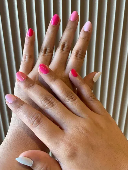 We love playing with shades. This manicure showcases a beautiful gradient of pinks, with each hand featuring five different tones from light to dark.