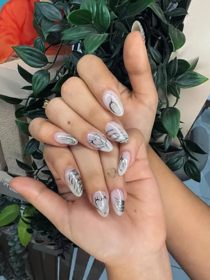 An abstract silver design on a clear extension, creating a cool, futuristic vibe. The hand-painted lines give it an artistic feel.