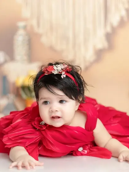 A curious glance from our little girl in red. I capture a variety of expressions during a session to show their full personality.