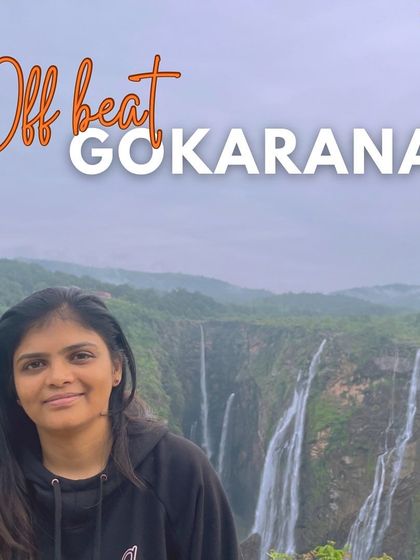 An offbeat Gokarna adventure, featuring a traveler with a stunning waterfall view in the background, showcasing the diverse scenery of the region.