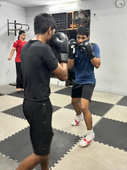 A partner drill focusing on defense and timing. One boxer throws a jab while the other practices blocking and maintaining a solid guard.
