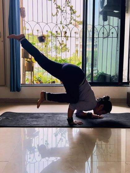 Finding strength and balance in a funky one-legged crow pose. I love exploring creative variations of classic asanas to challenge my body and mind in new ways.