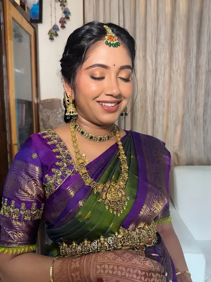 A close-up of the eye makeup for this Seemantham look. The soft golden shimmer on the lids adds a touch of celebration while keeping the overall look elegant.