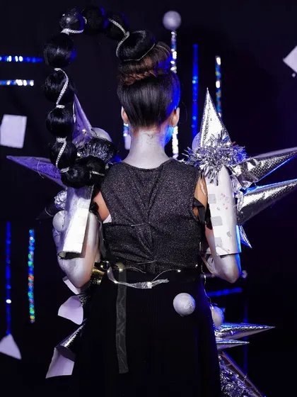 The back view of the robotic look, highlighting the complex bubble braid hairstyle and the detailed construction of the shoulder armor.