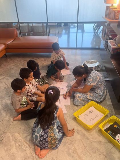 A group of little coders works together on their worksheets. Collaborative problem-solving is a key part of my unplugged coding sessions, teaching teamwork alongside computational thinking.