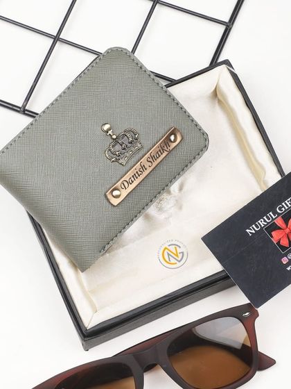 A sleek grey wallet personalized with a crown charm, perfect for a modern and stylish look.