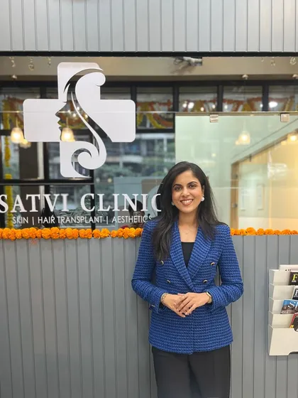 I believe in a partnership with my patients, and it all starts with a warm welcome. Here I am at the entrance to Satvi Skin Clinic, a space I designed to be professional, modern, and comfortable for everyone who walks through our doors.