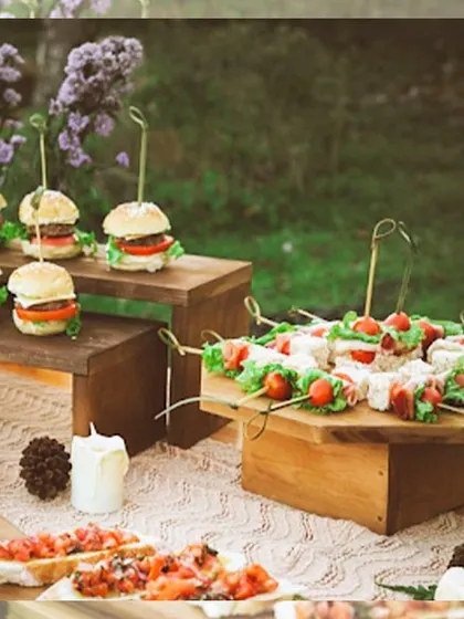 A beautiful outdoor spread of mini burgers and caprese skewers. This showcases our ability to cater to more casual, relaxed events with the same commitment to quality and presentation.