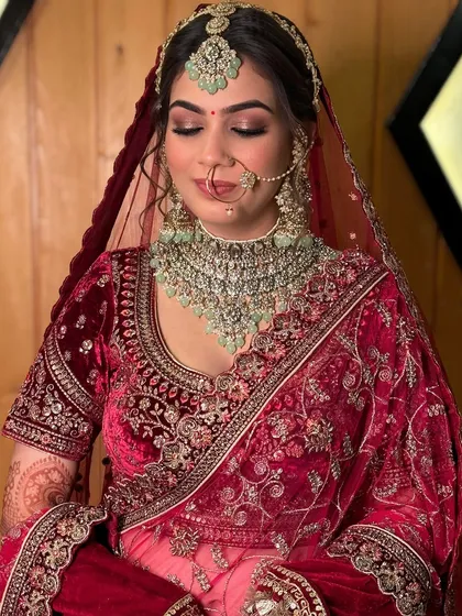 A detailed shot of the eye makeup for this luxe bridal look. The soft, smoky blend enhances her eyes, adding depth and dimension that complements her heavy jewelry and velvet outfit.