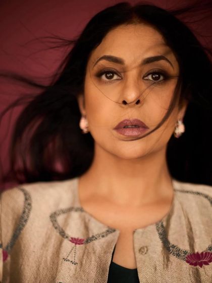 A striking, wind-swept portrait of Shefali Shah, highlighting the intricate embroidery on her gold brocade jacket from Raw Mango.