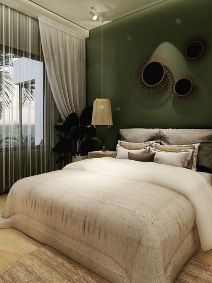 We used a deep olive green for the accent wall in this bedroom to create a cozy and intimate feel. Rattan pendant lights and wooden furniture add a natural, bohemian touch, complemented by the view of palm trees outside.